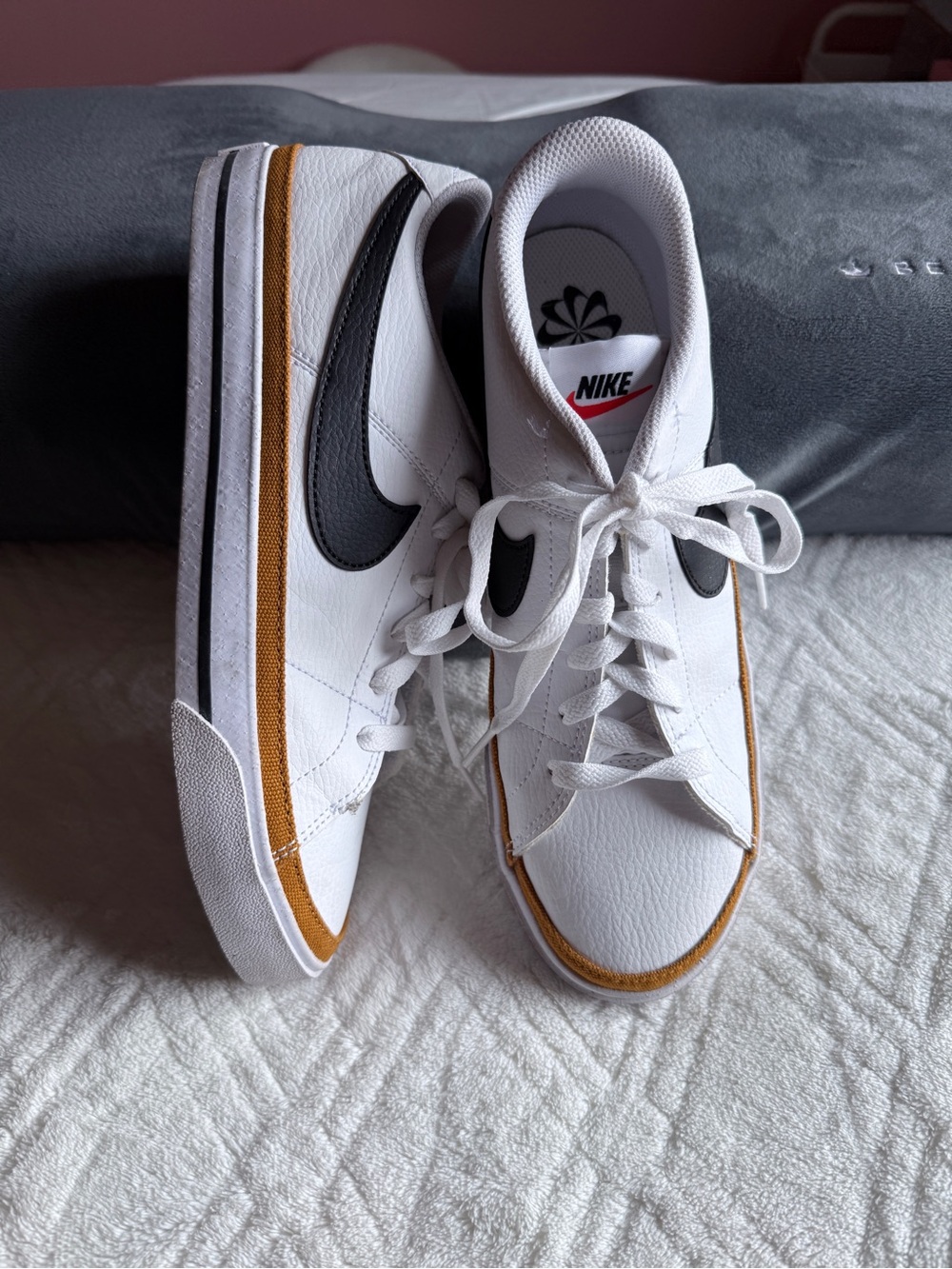 Nike White Low-Top Sneakers with Black Swoosh and Mustard Trim